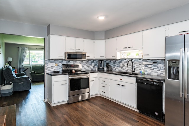 730 Maplecrest Dr, Troy, OH 45373 - kitchen featuring appliances with stainless steel finishes, a sink, dark countertops, decorative backsplash, and white cabinets