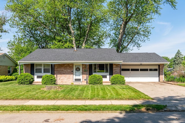 730 Maplecrest Dr, Troy, OH 45373 - view of front facade with brick siding, an attached garage, driveway, and a front lawn