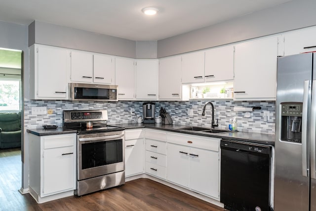 730 Maplecrest Dr, Troy, OH 45373 - kitchen featuring stainless steel appliances, a sink, dark wood-style flooring, dark countertops, and white cabinets