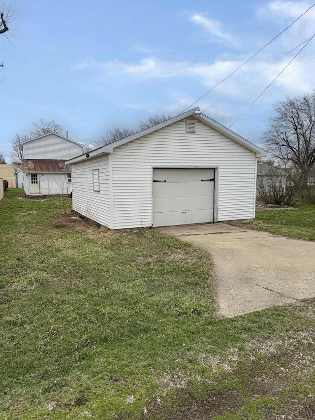 detached garage featuring driveway