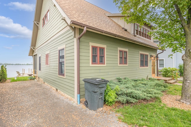 7933 Hickory Ave, Russells Point, OH 43348 - view of side of property with a shingled roof and a water view