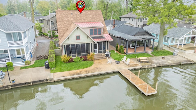 7933 Hickory Ave, Russells Point, OH 43348 - rear view of property featuring a sunroom, a residential view, metal roof, a standing seam roof, and a deck with water view