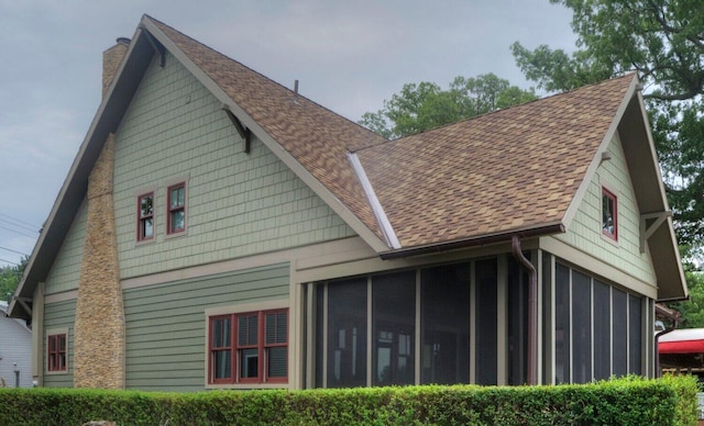 7933 Hickory Ave, Russells Point, OH 43348 - view of side of property with a chimney, a sunroom, and roof with shingles
