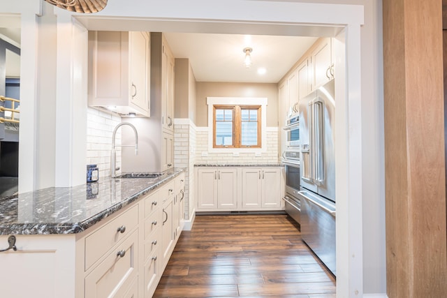 7933 Hickory Ave, Russells Point, OH 43348 - kitchen featuring a sink, dark wood-style flooring, tasteful backsplash, a warming drawer, and high quality fridge