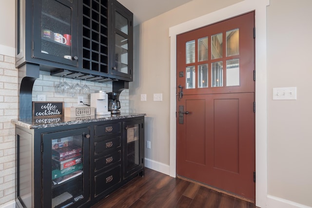7933 Hickory Ave, Russells Point, OH 43348 - indoor dry bar featuring backsplash, dark wood finished floors, and baseboards