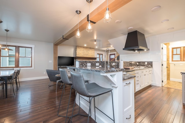 7933 Hickory Ave, Russells Point, OH 43348 - kitchen with range hood, dark wood-style floors, a kitchen breakfast bar, and dark stone countertops