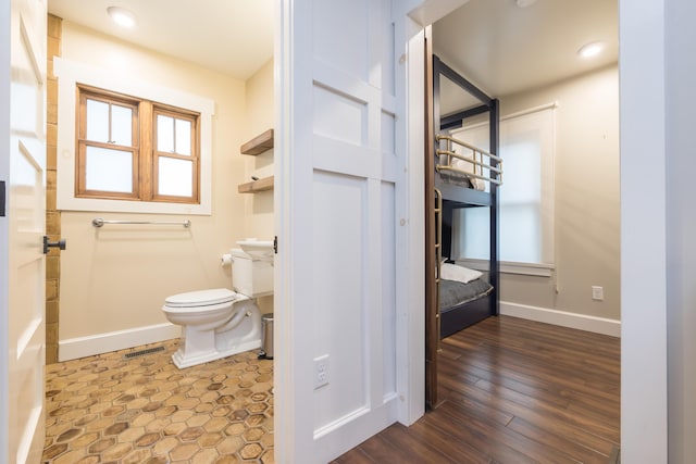 7933 Hickory Ave, Russells Point, OH 43348 - bathroom featuring toilet, baseboards, plenty of natural light, and wood finished floors