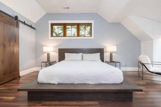 7933 Hickory Ave, Russells Point, OH 43348 - bedroom with a barn door, vaulted ceiling, baseboards, and dark wood-type flooring