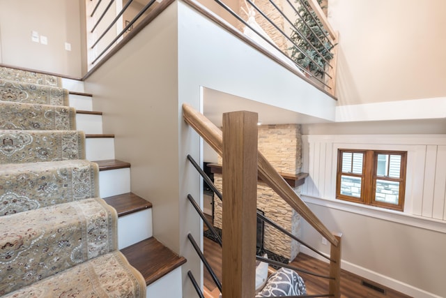 7933 Hickory Ave, Russells Point, OH 43348 - stairway featuring wood finished floors, baseboards, and a towering ceiling