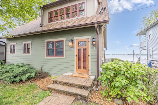 7933 Hickory Ave, Russells Point, OH 43348 - view of front of home with a water view and roof with shingles