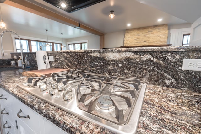 7933 Hickory Ave, Russells Point, OH 43348 - kitchen view of decorative backsplash, stainless steel gas cooktop, a sink, white cabinets, and recessed lighting
