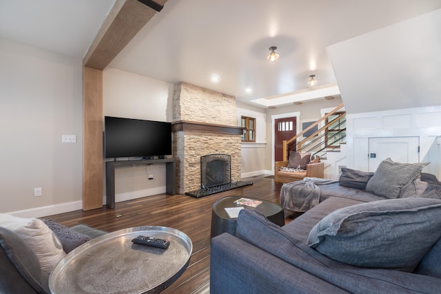 7933 Hickory Ave, Russells Point, OH 43348 - living area featuring stairs, wood finished floors, baseboards, and a stone fireplace