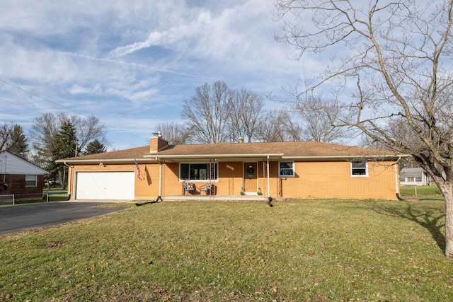 ranch-style home featuring aphalt driveway, brick siding, a chimney, and an attached garage