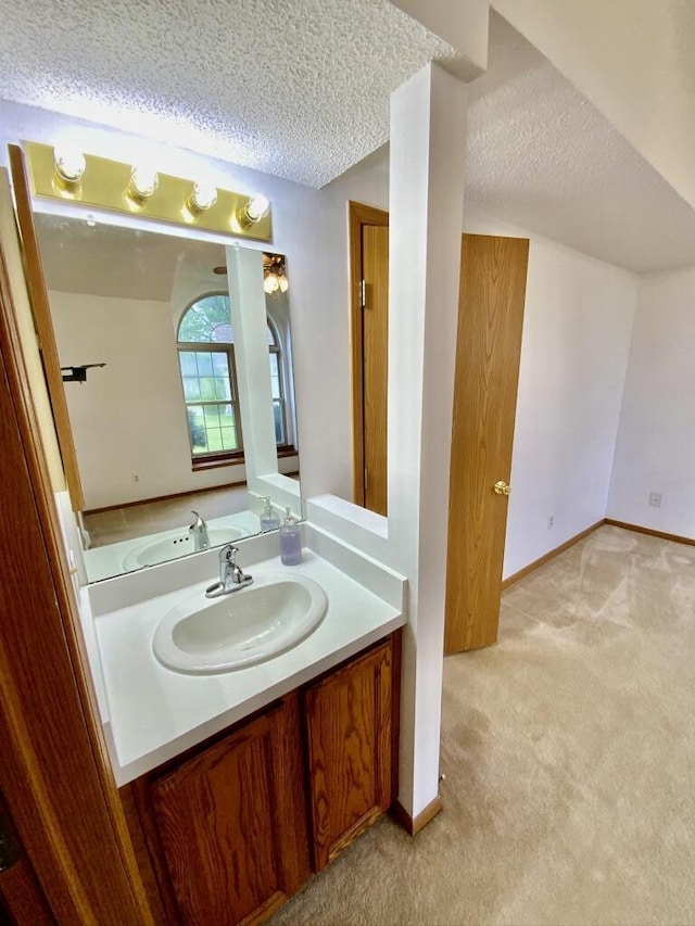 224 Oakcrest Ct, Russells Point, OH 43348 - bathroom with a textured ceiling, vanity, and baseboards
