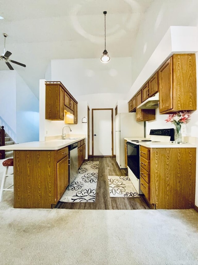 224 Oakcrest Ct, Russells Point, OH 43348 - kitchen with range with electric stovetop, under cabinet range hood, dishwasher, a ceiling fan, and brown cabinets