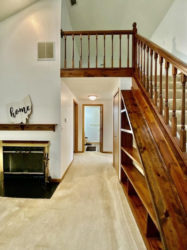 224 Oakcrest Ct, Russells Point, OH 43348 - hallway with carpet flooring, a high ceiling, baseboards, and stairway