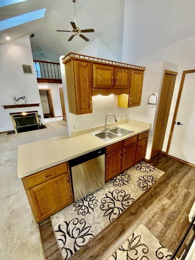 224 Oakcrest Ct, Russells Point, OH 43348 - kitchen with dishwasher, a sink, a skylight, a ceiling fan, and brown cabinets