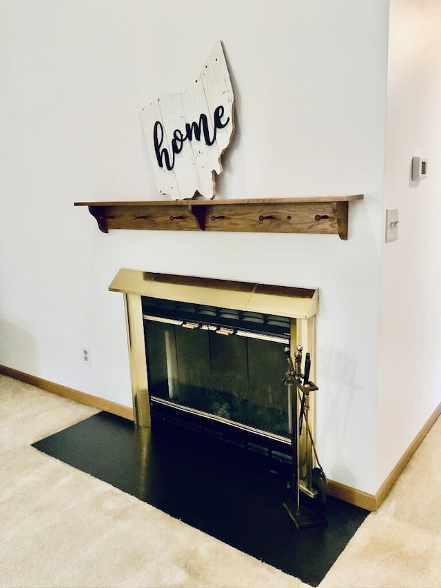 224 Oakcrest Ct, Russells Point, OH 43348 - detailed view of a glass covered fireplace, carpet floors, and baseboards