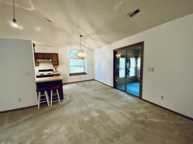 224 Oakcrest Ct, Russells Point, OH 43348 - dining area with vaulted ceiling, baseboards, and light carpet