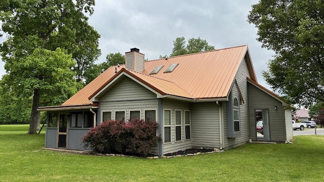 224 Oakcrest Ct, Russells Point, OH 43348 - rear view of house with a chimney, a yard, and metal roof