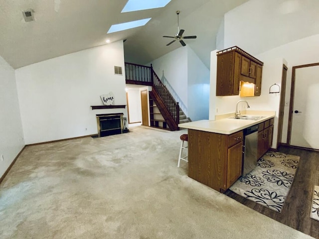224 Oakcrest Ct, Russells Point, OH 43348 - kitchen with a sink, a fireplace, dishwasher, high vaulted ceiling, and a ceiling fan