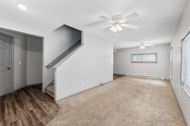 unfurnished living room with a ceiling fan, baseboards, stairs, a baseboard heating unit, and carpet flooring