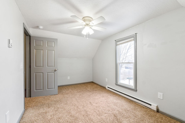 bonus room featuring lofted ceiling, baseboard heating, a ceiling fan, and carpet