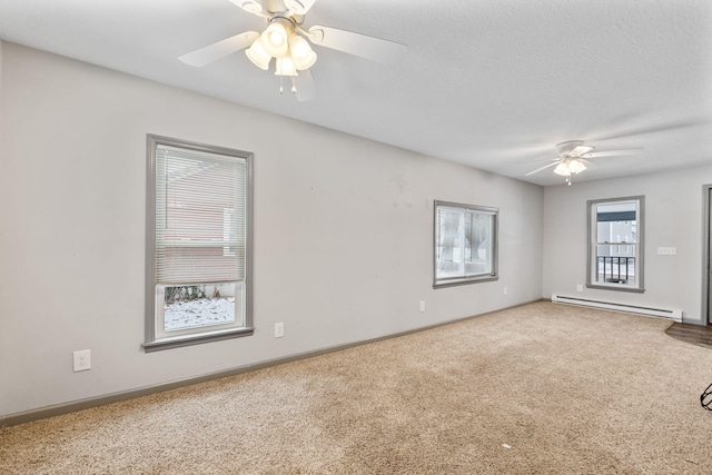 spare room featuring baseboards, ceiling fan, baseboard heating, carpet flooring, and a textured ceiling