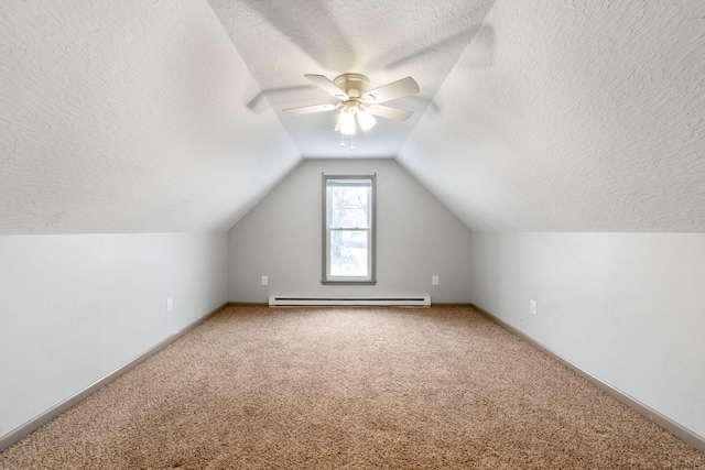 additional living space with light carpet, a textured ceiling, a baseboard heating unit, and lofted ceiling