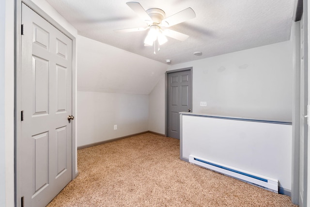 bonus room featuring ceiling fan, baseboards, lofted ceiling, light carpet, and a baseboard radiator