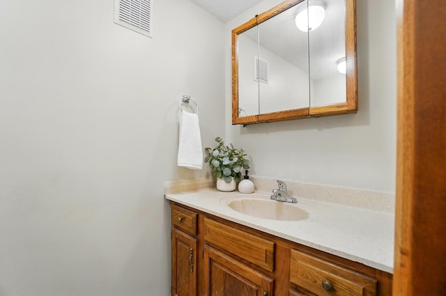 bathroom featuring visible vents and vanity