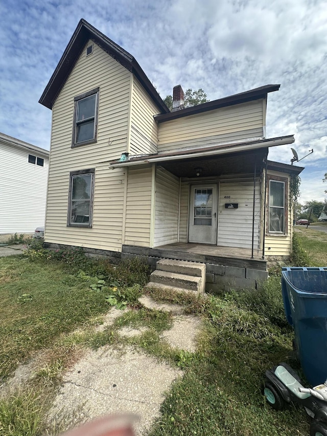 view of front facade with a front lawn and a porch