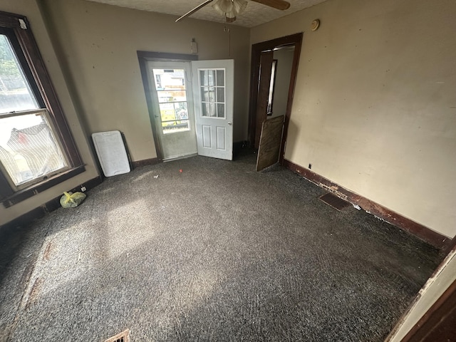 spare room featuring a textured ceiling, ceiling fan, and plenty of natural light