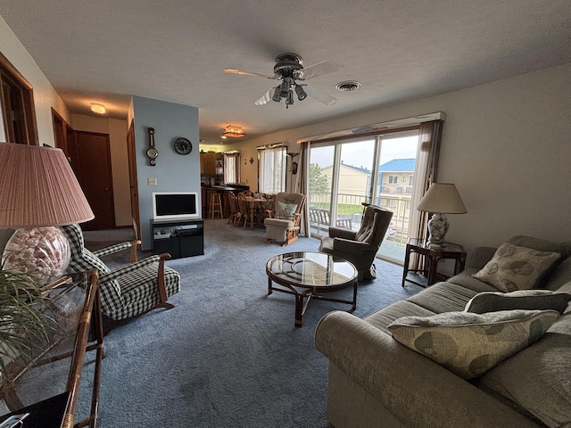 129 Chase Ave Unit 11U, Russells Point, OH 43348 - carpeted living room with a ceiling fan and a textured ceiling