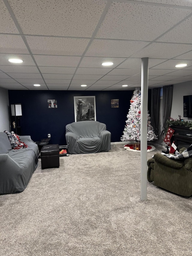 living room with carpet flooring and a drop ceiling