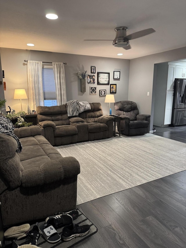 living room featuring ceiling fan and wood-type flooring