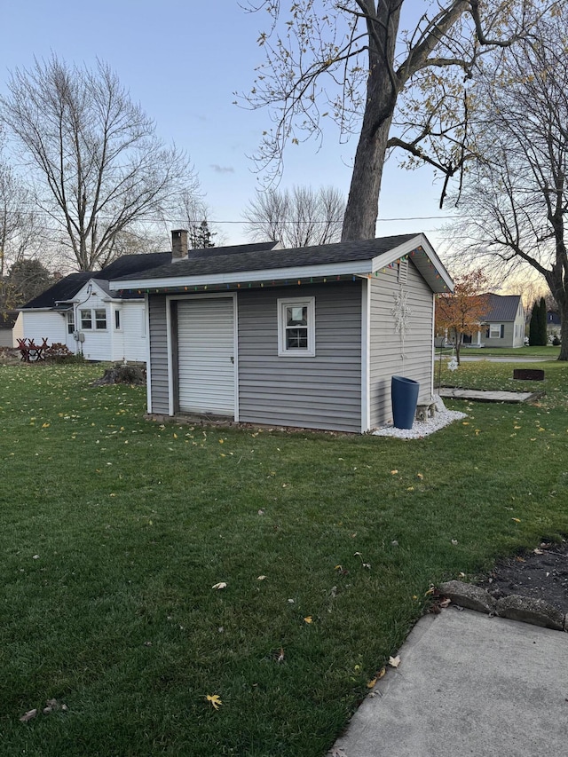 outdoor structure at dusk featuring a yard