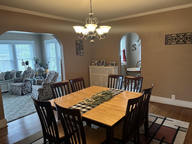 217 S 2nd St, Coldwater, OH 45828 - dining space with arched walkways, wood finished floors, ornamental molding, baseboards, and a chandelier