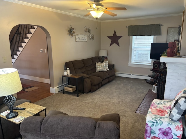 217 S 2nd St, Coldwater, OH 45828 - living area featuring a baseboard radiator, ornamental molding, arched walkways, a ceiling fan, and a fireplace