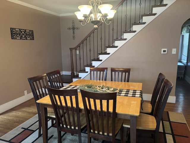 217 S 2nd St, Coldwater, OH 45828 - dining space with wood finished floors, a chandelier, baseboards, stairway, and arched walkways