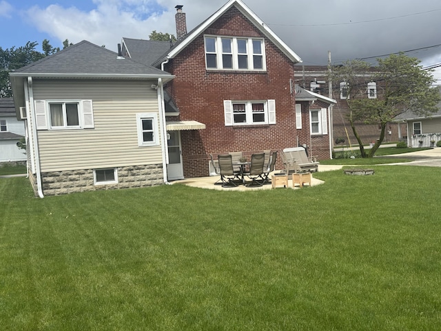 217 S 2nd St, Coldwater, OH 45828 - rear view of property featuring a yard, a chimney, a shingled roof, and a patio