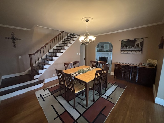 217 S 2nd St, Coldwater, OH 45828 - dining room featuring arched walkways, crown molding, wood finished floors, baseboards, and stairway