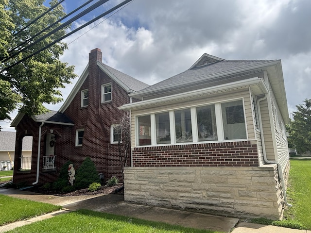 217 S 2nd St, Coldwater, OH 45828 - view of home's exterior with brick siding and a chimney