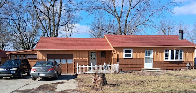 view of front of house featuring a garage and a front lawn