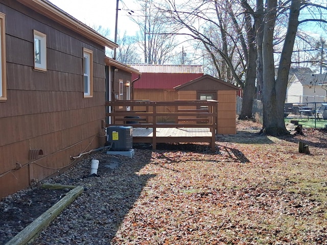 view of yard featuring central AC unit and a deck