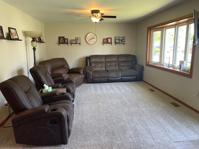 living room featuring carpet floors, a ceiling fan, and baseboards
