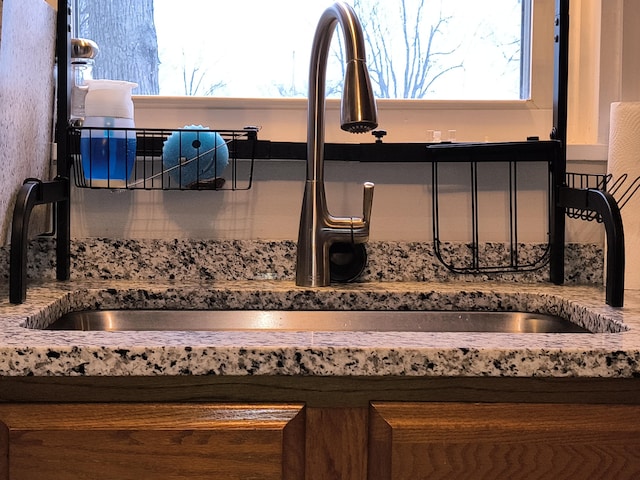 detailed view of a sink and stone countertops