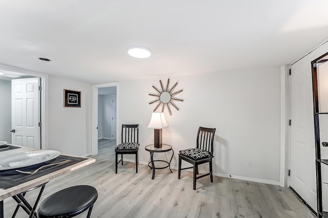 sitting room with light hardwood / wood-style floors