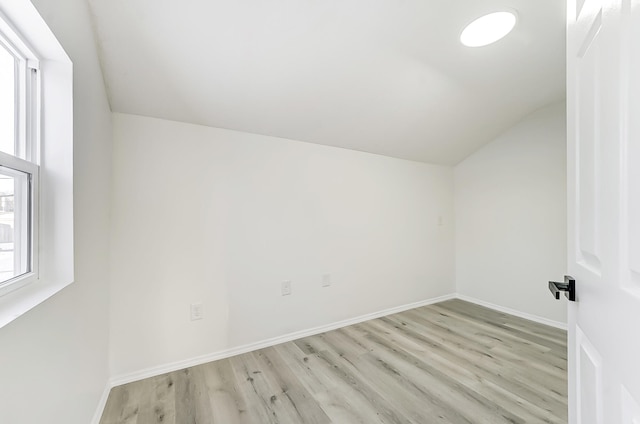 bonus room with vaulted ceiling and light hardwood / wood-style flooring