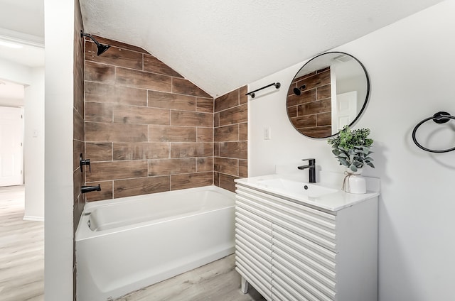 bathroom featuring washtub / shower combination, hardwood / wood-style floors, vaulted ceiling, and a textured ceiling